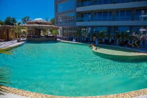 a large swimming pool in front of a building at Sea View Allure Studio with Balcony in Primorsko