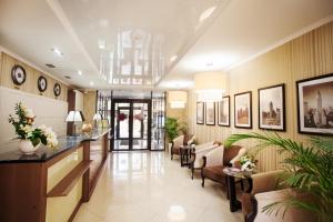 a lobby of a hotel with chairs and a reception desk at City & Business Hotel in Mineralnie Vody