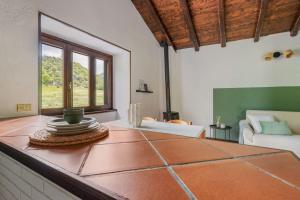 a living room with a table and a couch at Il Giardino Segreto in Barzio