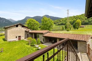 a view from the balcony of a house with mountains in the background at Il Giardino Segreto in Barzio