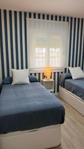 Postel nebo postele na pokoji v ubytování Punto Mágico, apartamento junto al mar + 26 fotografií