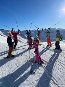 a group of children on skis in the snow at Les chryolles - Les mélèzes in Valmeinier