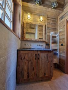 a kitchen with wooden cabinets and a sink at Les chryolles - Les mélèzes in Valmeinier +25 photos