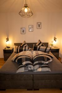 a bed with black and white pillows on it at Zimmer by Appartement Sporer in Hippach in Hippach