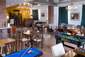 a restaurant with tables and a pool table at Hotel mia Telavi in Telavi