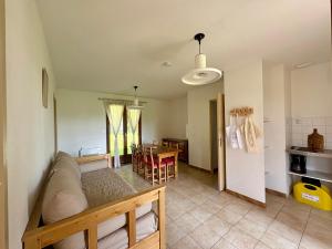 a living room with a couch and a table at Village de Gîtes La Perdicie in Jumilhac-le-Grand