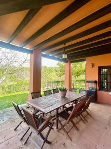 a wooden table and chairs on a patio at Hispalis Villa de Sanlúcar in Seville