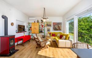 オミサリにあるOne Bedroom Beautiful Home In Omisaljのリビングルーム(黄色のソファ、暖炉付)