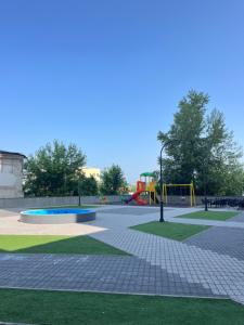 a park with a playground and a play area at Ilidža Tower Sapphire Suites in Sarajevo