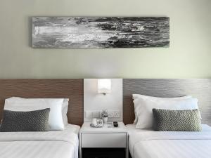 Amansari Hotel Desaru客房内的一张或多张床位