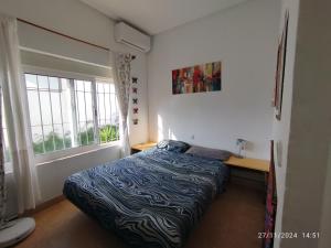 a small bedroom with a bed and a window at Relax Ferrandiz in Málaga +73 photos
