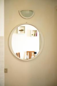 a mirror in a room with a book shelf at The new "Bilocale vista mare" 2025 in Fano +11 photos