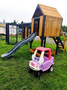 a toy car on a slide next to a playground at Wśród Gór in Istebna