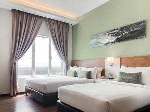 Amansari Hotel Desaru客房内的一张或多张床位