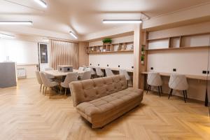 a living room with a couch and a table and chairs at Luxx Aparts in Almaty