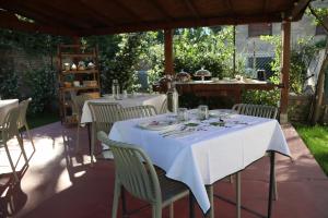 a table with white table cloths and chairs on a patio at Civico 99 in Ravenna