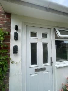 a white garage door with a sign on it at Studio 40 cosy compact space in quiet location in Seaford in Seaford
