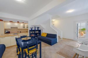 a living room with a blue table and a blue couch at Thanos Luxurious Apt in Spetses Center, 2BR, 2BA in Spetses