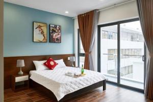 a bedroom with a bed and a large window at Nguyên Hương Hotel in Ho Chi Minh City