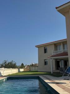 a swimming pool in front of a house at Maison Andre in Pano Lefkara