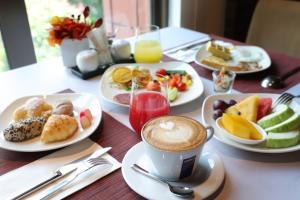 a table with plates of food and a cup of coffee at Grand Victoria Hotel in Taipei