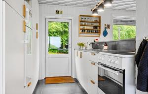 a white kitchen with a sink and a stove at 3 Bedroom Amazing Home In Fur in Fur