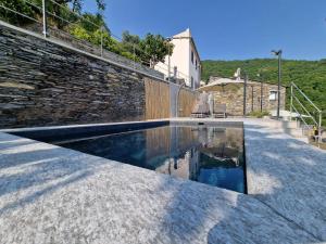 a swimming pool in front of a brick wall at Dimore d'Oltremare - Appartamento Libeccio in Lavagna