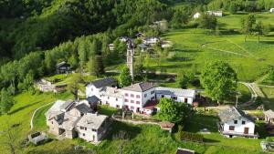 an aerial view of a village on a green hill at Locanda e Ristoro MALETTO in Carema