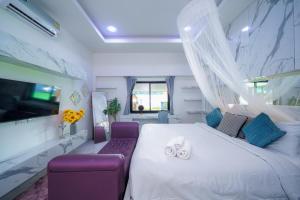 a bedroom with a white bed and purple furniture at Kate Pool Villa Jomtien Pattaya in Pattaya +130 photos