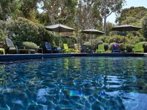 a swimming pool with chairs and umbrellas at Fianca l'Osso in Belvédère +12 photos