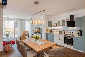 a kitchen and dining room with a table and chairs at Ferienhaus Nordwind in Kolpinsee