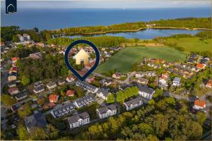 an overhead view of a suburb with a blue arrow at Ferienhaus Nordwind in Kolpinsee