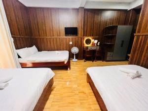 Postel nebo postele na pokoji v ubytování Khách sạn Đoàn Vượng Đà Lạt