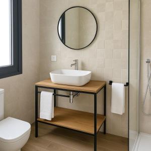 ein Badezimmer mit Waschbecken und Spiegel in der Unterkunft Hotel Síbel Baza in Baza