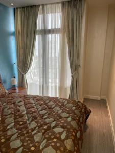 a bedroom with a bed and a large window at Chic City Oasis at Gazebo in Addis Ababa +40 photos