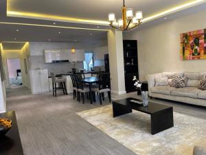 a living room with a couch and a table at Chic City Oasis at Gazebo in Addis Ababa