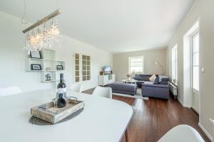 a living room with a white table and a couch at Ferienhaus Witt in Neue Tiefe Fehmarn