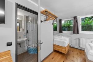 a bathroom with a tub and a sink and a toilet at Hotel Comenius in Berlin +84 photos