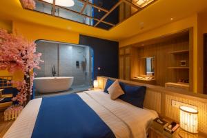 a bedroom with a large bed and a bath tub at Chiic House Hotel - Love Hotel in Nha Trang +27 photos