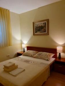 een slaapkamer met een bed met handdoeken erop bij Pelješka OREBIĆ in Orebić