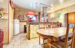 a kitchen and dining room with a wooden table at Nice Home In Proissans in Proissans +32 photos