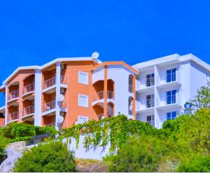 a large apartment building on top of a hill at Open Sky Montenegro in Utjeha