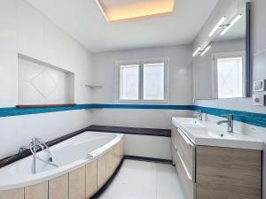 a bathroom with two sinks and a large tub at Le relais - Groupe - BBQ - babyfoot - pingpong- netflix- clim in Horsarrieu +14 photos