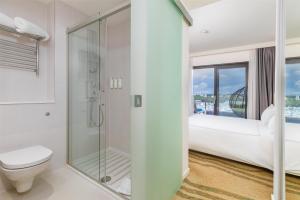 a bathroom with a shower and a toilet at Park Plaza Histria Pula in Pula