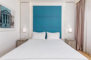 a bedroom with a large white bed with two night stands at Park Plaza Histria Pula in Pula