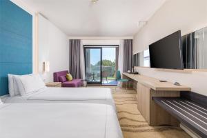 a hotel room with a bed and a flat screen tv at Park Plaza Histria Pula in Pula
