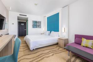 a hotel room with a bed and a couch at Park Plaza Histria Pula in Pula