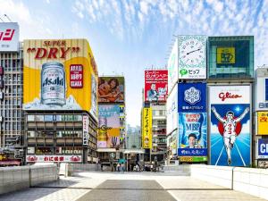 a group of buildings with signs in a city at Swissotel Nankai Osaka in Osaka