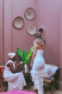 a woman standing next to a woman in a room at Binta Boutique Hotel - Small Oasis near Nungwi Beach in Nungwi