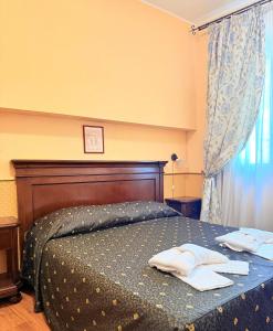 Letto o letti in una camera di Hotel Archimede Ortigia